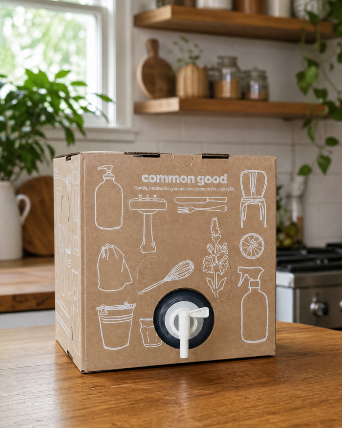 Common Good 2.5 gallon refill box with reusable spigot on a shelf.